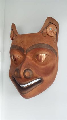 a wooden mask hanging on the wall