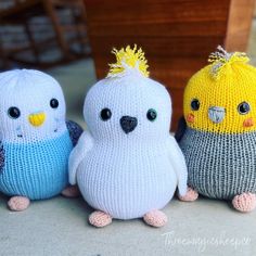 three knitted birds sitting next to each other