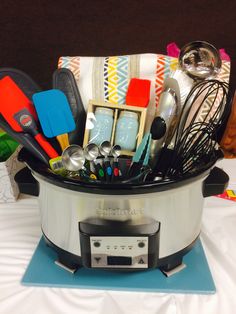 a crock pot filled with kitchen utensils