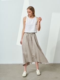 Ruffled linen skirt with an elastic waistline and laces. Laces give casual sportiness that nicely contrast with the draping of romantic pleats. Wavy bottom hemline (sides are longer than the front and back) makes this flared linen skirt even more exquisite. Side pockets add extra convenience. This midi A-line skirt looks good both in neutral and bold colors. It is a perfect companion for going out to the city but also can make your vacation more memorable. STYLE DETAILS * Flared linen skirt * El White Pleated Linen Skirt, Flowy Linen Skirt With Elastic Waistband, Linen Full Skirt With Elastic Waistband, Full Linen Skirt With Elastic Waistband, Beige Linen Skirt With Elastic Waistband, Gathered Linen Maxi Skirt, Casual Flared Linen Skirt, Linen Maxi Skirt With Elastic Waistband, Beige Linen Pleated Skirt