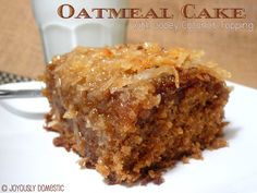 a close up of a piece of cake on a plate with a glass in the background