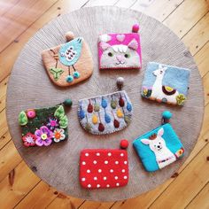 several small purses sitting on top of a wooden table