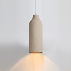 a white light hanging from a ceiling in a room with no one on the floor