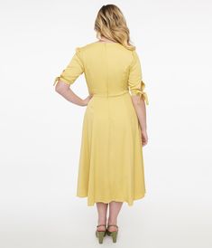 This vibrant yellow 1940s style dress features a flattering v-neck and charming half sleeves with a keyhole self tie on the cuff for added flair. The convenient back zipper and side pockets make it both stylish and practical for any occasion.Available in sizes XS-4X while supplies last. 1940s Fashion Dresses, Yellow Maxi Dress, 1940s Style, Yellow Maxi, 1940s Fashion, Style Dress, Swing Dress, Half Sleeves, Unique Vintage