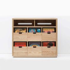 a wooden bookcase with many books on it and some drawers in front of it