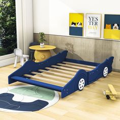 a child's bed with wheels on the bottom and sides is shown in an empty room