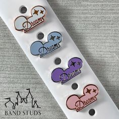 the disney mouse buttons are in different colors and sizes, along with their name on them