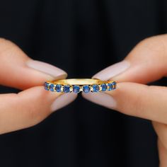 Product Details This stunning Half Eternity Band Ring is graced with the brilliance of Round Shape Created Blue Sapphire Gemstones, delicately placed along the band in a Floating Setting. Each gemstone appears to effortlessly float, creating a mesmerizing and elegant design. Product Information SKU SHP-RINGS052182020 Width 2 mm Height 2.1 mm Weight 2.00 gm (Approximate) LAB CREATED BLUE SAPPHIRE INFORMATION No.of Stones 14 Pieces Total Weight 0.56 Carat (Approximate) Dimension(approx) Round-2X2 Half Eternity Band, Eternity Band Ring, 18k Yellow Gold Ring, Blue Sapphire Rings, Eternity Band, Sapphire Gemstone, Design Product, Eternity Bands, Yellow Gold Rings