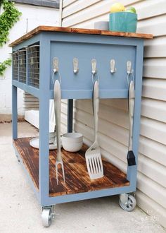 an outdoor kitchen cart with utensils on it