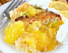 a close up of a plate of food with lemons and whipped cream on it