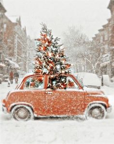 an old red car with a christmas tree on top