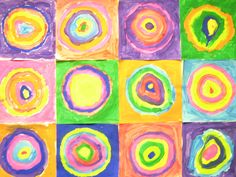 an art project made with colored paper and paint on the wall, including circles in different colors