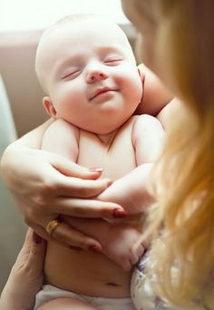 a woman holding a baby in her arms with the caption mother's lap