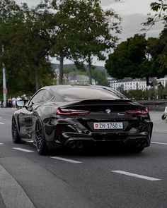 a black sports car driving down the road