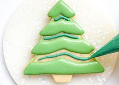 a cookie decorated like a christmas tree on a plate