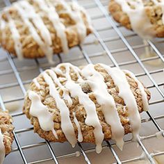 several cookies with icing sitting on a cooling rack