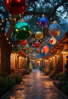 an outdoor walkway with lights and ornaments hanging from the trees over it's head