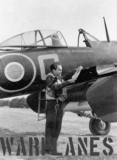 a man standing next to an airplane on top of a field