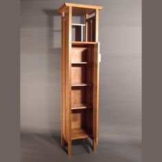 a tall wooden shelf with shelves in it