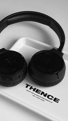 two black headphones sitting on top of a white tray with the word thience printed on it