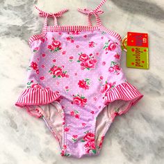 Cute Pink Floral Swimsuit Size 12 M. Nwt Bought At Nordstroms! Pink Fitted Onesie For The Beach, Spring Beach Fitted Onesie, Cute Fitted Swimming Onesie, Cute Fitted Beach Onesie, Cute Fitted Onesie For Beach, Cute Fitted Onesie For Swimming, Fitted Summer Beach Onesie, Cute Fitted Onesie For The Beach, Swimsuit Pink