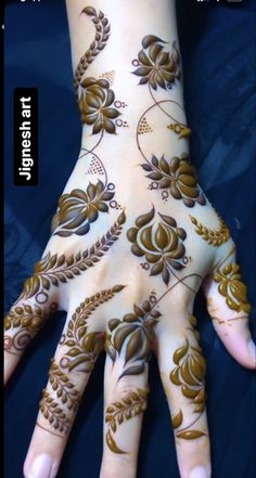 the hand is decorated with flowers and leaves