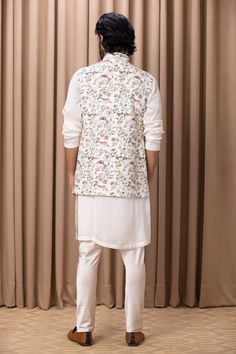 Off white nehru jacket with floral hand painted digital prints.
Component: 1
Pattern: Digital Print
Type Of Work: Floral Patterns
Neckline: Mandarin Collar
Sleeve Type: Sleeveless
Fabric: Cotton Silk, Lining: Twill Satin
Color: Off White
Other Details: 
Note: Kurta and pant worn by the model is not for sale
Occasion: Sangeet - Aza Fashions White Bandhgala For Spring Designer Wear, Spring White Nehru Jacket With Floral Print, White Cotton Nehru Jacket With Floral Embroidery, Spring Designer Nehru Jacket With Printed Motifs, Transitional Printed Nehru Jacket, Spring Nehru Jacket With Printed Motifs For Designer Wear, Festive White Nehru Jacket With Floral Print, Spring Nehru Jacket With Printed Motifs, Transitional Season Printed Nehru Jacket