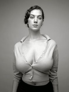 a black and white photo of a woman wearing a shirt with buttons on the chest