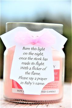 a pink candle with a poem on it