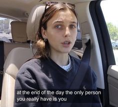 a woman sitting in the back seat of a car