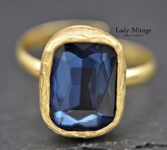 Modern and timelessly elegant, this ring adds a touch of sophistication to any outfit. Whether worn for a special occasion or in everyday life, it will perfectly complement your look. Discover our elegant rectangular ring made of gold-plated brass, adorned with sparkling sapphire-blue crystal stones. Add a touch of elegance to your outfit with this dazzling ring. Pair it with our matching earrings and necklaces from our shop to complete your look:  https://ladymiragedesign.etsy.com/listing/16972 Elegant Sapphire Ring With Rectangular Stone, Blue Gold-plated Rings For Gifts, Gold Jewelry With Rectangular Stone For Wedding, Blue Gold Plated Rings As Gift, Blue Gold Plated Rings For Gift, Gold Plated Blue Rings As Gift, Adjustable Elegant Sapphire Ring Anniversary, Elegant Sapphire Crystal Ring As Gift, Gold Rectangular Sapphire Promise Ring