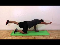 a man is doing an exercise on a green mat