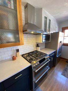 a stove top oven sitting inside of a kitchen