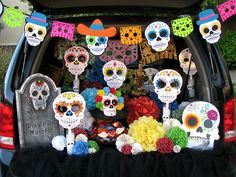 a car decorated with sugar skulls and flowers