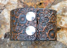 This by far one of the most stunning handcrafted 2 inch WIDE BRACELET CUFFS! It has such artistic detail with a gorgeous flower garden with a hidden butterfly just minding her own business as happy as she can be amongst all the flowers. It is stained stained a lovely antique medium brown. Two durable snaps hold this bracelet together. Surely a brilliant accessory to any outfit!Made with 100% leather! Though it is sealed twice for water resistance and durability, if water does get on it please wi Handmade Adjustable Nature-inspired Cuff Bracelet, Handmade Adjustable Cuff Bracelet, Hand Tooled Cuff Bracelets As A Gift, Hand-tooled Cuff Bracelets As Gift, Hand Tooled Cuff Bracelet For Gift, Hand Tooled Cuff Jewelry For Gifts, Hand Tooled Cuff Bracelet As Gift, Adjustable Hand-tooled Cuff Bracelet For Gifts, Vintage Hand Tooled Cuff Bracelet As Gift