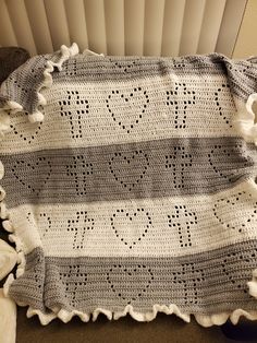 a crocheted blanket with the word love written on it