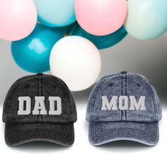 "If you're looking for a gift that's both unique and personal, look no further than the Mom & Dad Embroidered Dad Hat. This stylish cap is the perfect way to announce your pregnancy in style, and it also makes a great gift for new parents-to-be. The hat is made of high-quality materials, and features intricate varsity lettered embroidery work that reads \"Mom\" and \"Dad\". It's adjustable, so it can be worn by anyone, and its color scheme means it will go with any outfit. Whether you're looking for a gift for yourself or for someone else, the Mom & Dad Embroidered Dad Hat is sure to please. * 100% cotton twill * 6-panel unstructured cap with a low profile * 6 sewn eyelets * Black sweatband * Metal snap buckle with an antique brass finish * Washed-out vintage effect 📦 Shipping & Handling Personalized Cotton Birthday Hat, Father's Day Gift Trucker Hat With Curved Brim, Letter Print Hat For Father's Day Gift, Adjustable Hats As Father's Day Gifts, Father's Day Gift Baseball Cap With Curved Brim, Letter Print Trucker Hat With Curved Brim, Father's Day Gift Hats With Letter Print, Curved Brim Baseball Cap For Father's Day, Letter Print Baseball Cap For Father's Day