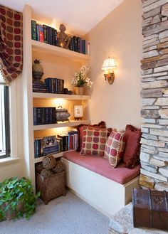 a living room filled with lots of books and furniture