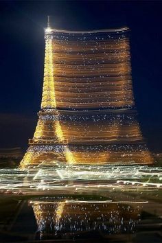 the eiffel tower is lit up at night