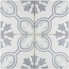 a white and gray tile with leaves on it