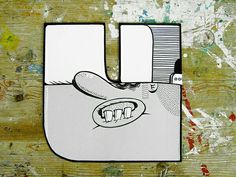 a paper cutout of a hand holding a cell phone with the letter u on it