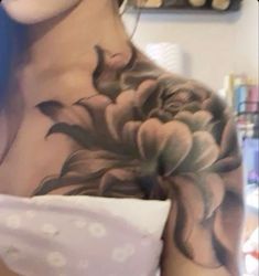 a woman with a flower tattoo on her chest