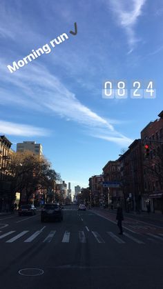 an image of a city street with cars driving down it and the sky in the background