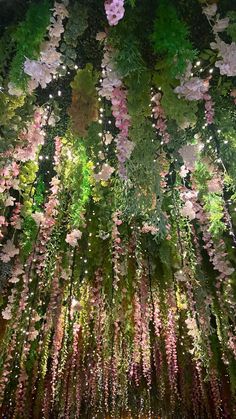 the ceiling is covered with flowers and plants in shades of pink, green and purple