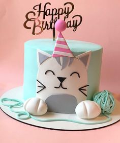 a birthday cake with a cat wearing a party hat