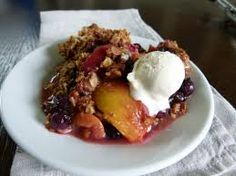 a close up of a plate of food with fruit and ice cream on the top