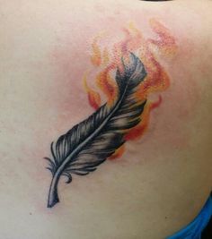 a woman with a tattoo on her back has a feather and flames in the background