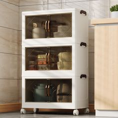 a white cabinet with glass doors and shelves filled with pots, pans, and other kitchen items