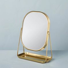 a mirror sitting on top of a metal stand