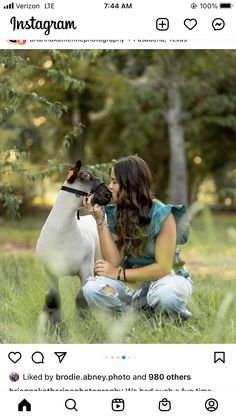 a woman kneeling down next to a dog in the grass with an instagram button